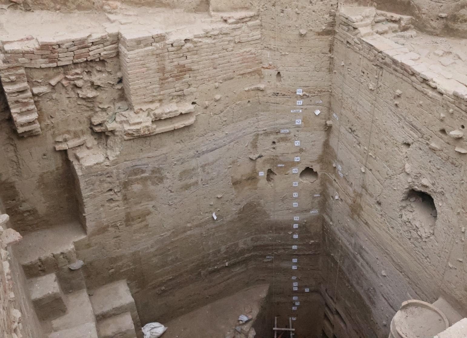 A section face at Bahaj showing dozens of thin archaeological layers and ash-filled pits