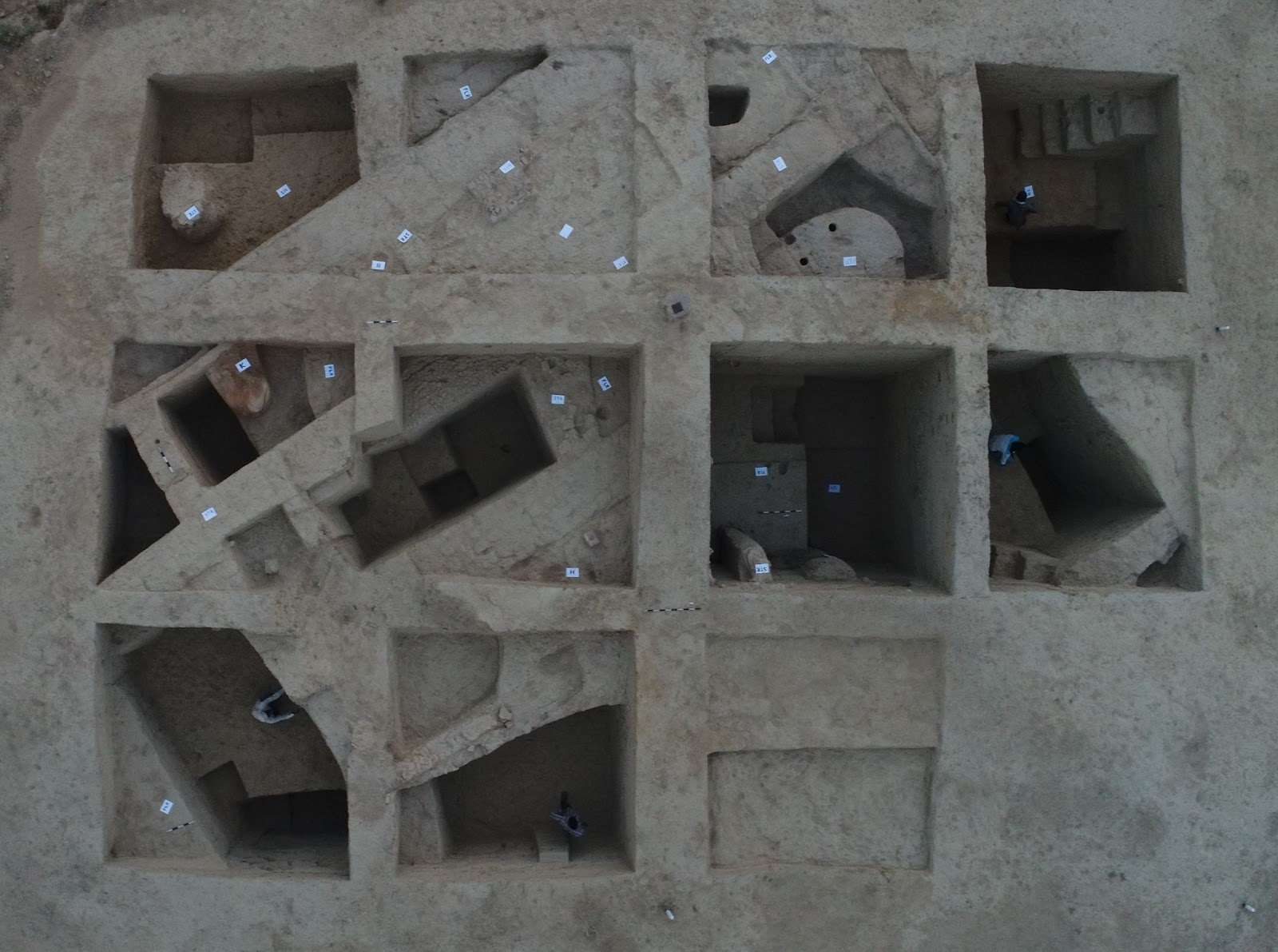 An aerial view of a grid of excavation quadrants opened across a mound