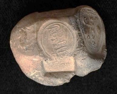 A cubical clay sealing with impressions on several faces